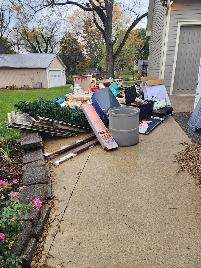 Dumpster being loaded with debris for 30 Yard Dumpster Rental in Burns